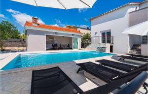 a villa with a swimming pool and a house at Villa Feniks in Polača