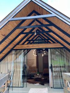 a barn with a wooden roof and glass doors at Cabanas Bela Vista in Rolante