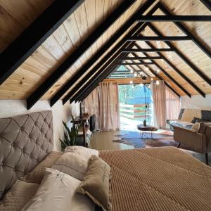 a bedroom with a bed and a living room at Cabanas Bela Vista in Rolante
