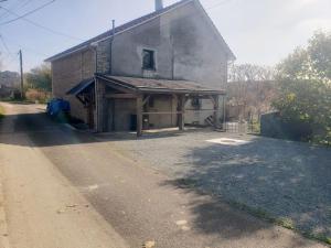 a large building with a porch on the side of a road at Appartement Au petit bonheur in Faimbe