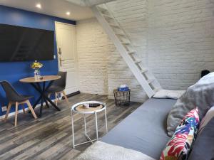 a living room with a couch and a table at La Marine - Centre ville - Wifi in Lens