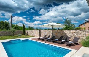 a swimming pool with chairs and an umbrella at Villa Nada in Ružići +35 photos