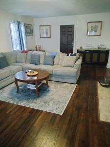 a living room with a couch and a coffee table at Upper Floorer in Montgomery