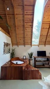 a large room with a wooden ceiling with a bath tub at Cabanas Bela Vista in Rolante