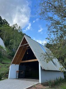 a barn with a metal roof on top of it at Cabanas Bela Vista in Rolante