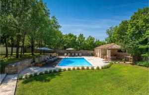 a backyard with a swimming pool and a stone building at Villa Roveria in Butkovići