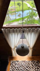 a large window with a chandelier in a room at Cabanas Bela Vista in Rolante