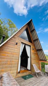 a cabin with a large window on a deck at Cabanas Bela Vista in Rolante