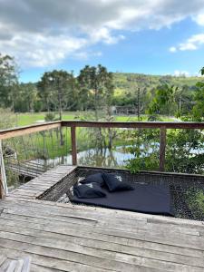 an umbrella is laying on a wooden deck at Cabanas Bela Vista in Rolante