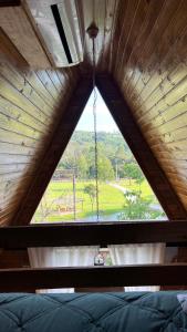 a large window in a room with a swing at Cabanas Bela Vista in Rolante