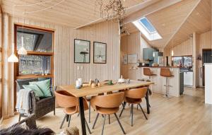 a kitchen and dining room with a wooden table and chairs at Holiday Home Tangvej Ørsted Iv in Kare