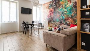 a living room with a couch and a table at Suite & Lake - Proche du Lac d'Annecy in Annecy