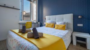 a bedroom with a bed with two stuffed animals on it at Suite & Lake - Proche du Lac d'Annecy in Annecy
