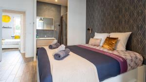 a bedroom with a large bed with towels on it at Suite & Lake - Proche du Lac d'Annecy in Annecy +10 photos