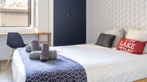 a bedroom with a bed with two stuffed animals on it at Suite & Lake - Proche du Lac d'Annecy in Annecy