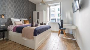 a bedroom with a bed and a desk and a computer at Suite & Lake - Proche du Lac d'Annecy in Annecy