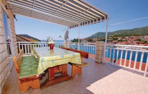 a table on a balcony with a view of the water at 4 Bedroom Beautiful Apartment In Brna in Brna