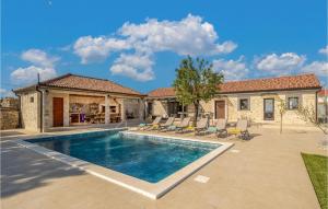 a swimming pool in front of a house at Villa Tany in Dračan