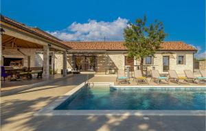 a swimming pool with chairs and a house at Villa Tany in Dračan +31 photos
