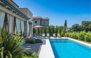 a swimming pool in the backyard of a house at Villa Calma in Šivati