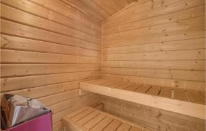 a wooden sauna with a bench and a trash can at Holiday Home Teglbakken Iv in Egernsund +14 photos