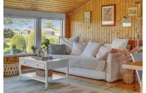a living room with a white couch and a table at Holiday Home Teglbakken Iv in Egernsund