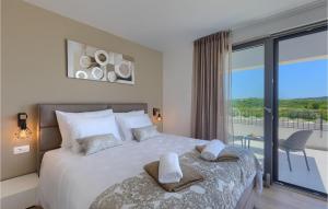 a bedroom with a large bed and a balcony at Villa Luna in Brtonigla
