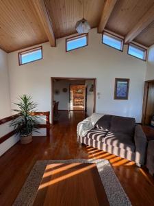 a large living room with a couch and windows at Little Slice of Paradise in Hat Head