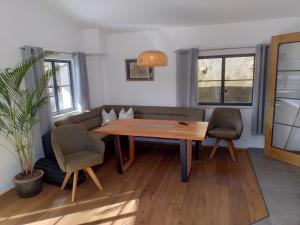 a living room with a wooden table and chairs at Ferienwohnung Gerhard Danner in Kiefersfelden