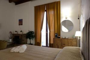 Postel nebo postele na pokoji v ubytování Palazzo Matilde