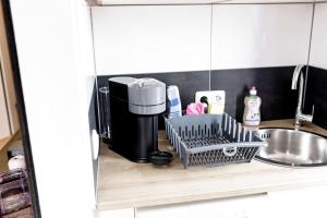 a kitchen counter with a coffee maker and a sink at Gemütliches Wohnen in Düren in Düren - Eifel