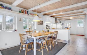 a kitchen and dining room with a table and chairs at Cozy Home In Glesborg With Kitchen in Glesborg
