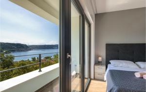 a bedroom with a balcony with a view of the water at Villa Adria Blue in Bakarac