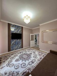 a room with a large rug on the floor at Жан Айсулу in Türkistan +1 photo