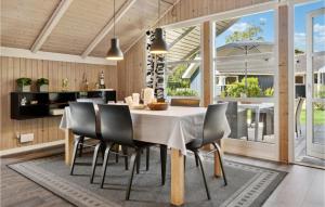 a kitchen and dining room with a table and chairs at Three-Bedroom Holiday Home In Sydals in Skovbyballe