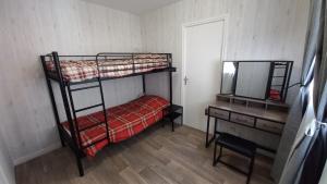 a bedroom with two bunk beds and a mirror at Au Katalu in Pléaux