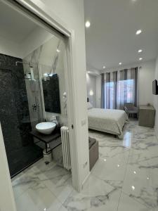 a bathroom with a sink and a shower and a bed at Alba White in Rome +24 photos