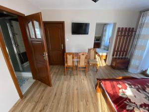 a living room with a table and a dining room at Domek pod lasem in Białka Tatrzanska