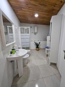 a white bathroom with a sink and a toilet at Casa Erika in Hermigua +18 photos