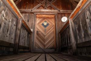 an inside view of a wooden door in a building at Pineta Natural Chalet in Coredo