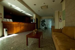 a living room with a couch and a coffee table at Hotel Pombeira in Guarda