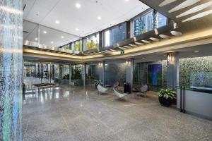 a large lobby with chairs and tables in a building at Central Downtown Highrise Condo in Vancouver