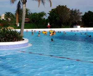 a group of people swimming in a swimming pool at Yovalu1 Apartamento En Torrevieja C in Torrevieja