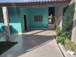 a patio in a house with a blue wall at Alexandre's house in Piranhas