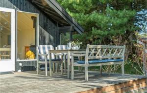 a wooden table and chairs on a deck at Beautiful Home In Humble With Wifi in Humble +11 photos