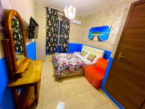 a bedroom with a bed and a red chair at Relaxon Guest House in Rome