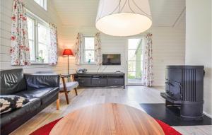 a living room with a couch and a table at Cozy Home In Ebeltoft With Sauna in Ebeltoft