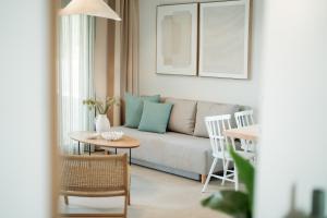 a living room with a couch and a table at Magnolia Villas Potos Thassos in Potos