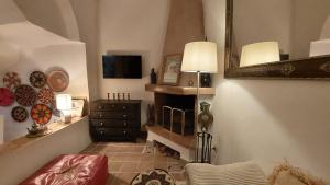 a living room with a fireplace and a mirror at DAR MOUIMA in Tangier