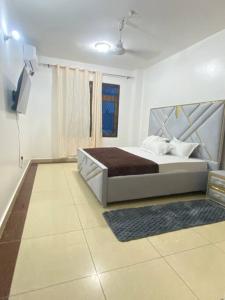 a bedroom with a large bed and a window at Ocean view homes in Mombasa